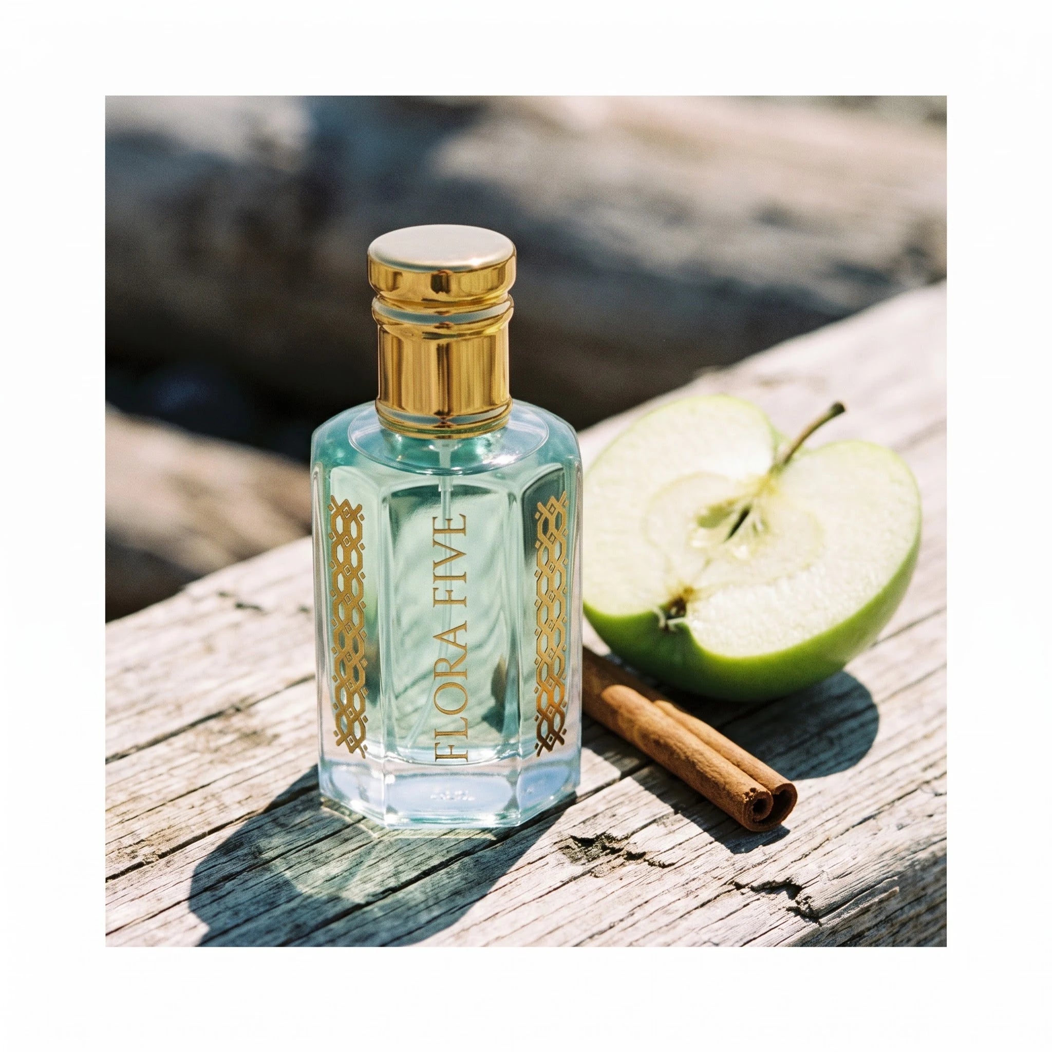Rasasi Hawas Inspired Attar by Flora Five — bottle on weathered wood beside a halved green apple and a cinnamon stick