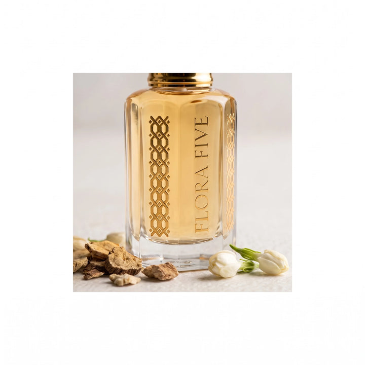 Sandal Aura Attar by Flora Five — close-up of the engraved bottle with orris root pieces and jasmine buds