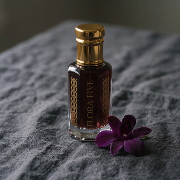 Tom Ford Black Orchid inspired attar for women — alcohol-free attar oil by Flora Five: dark plum oil on grey linen with a purple orchid