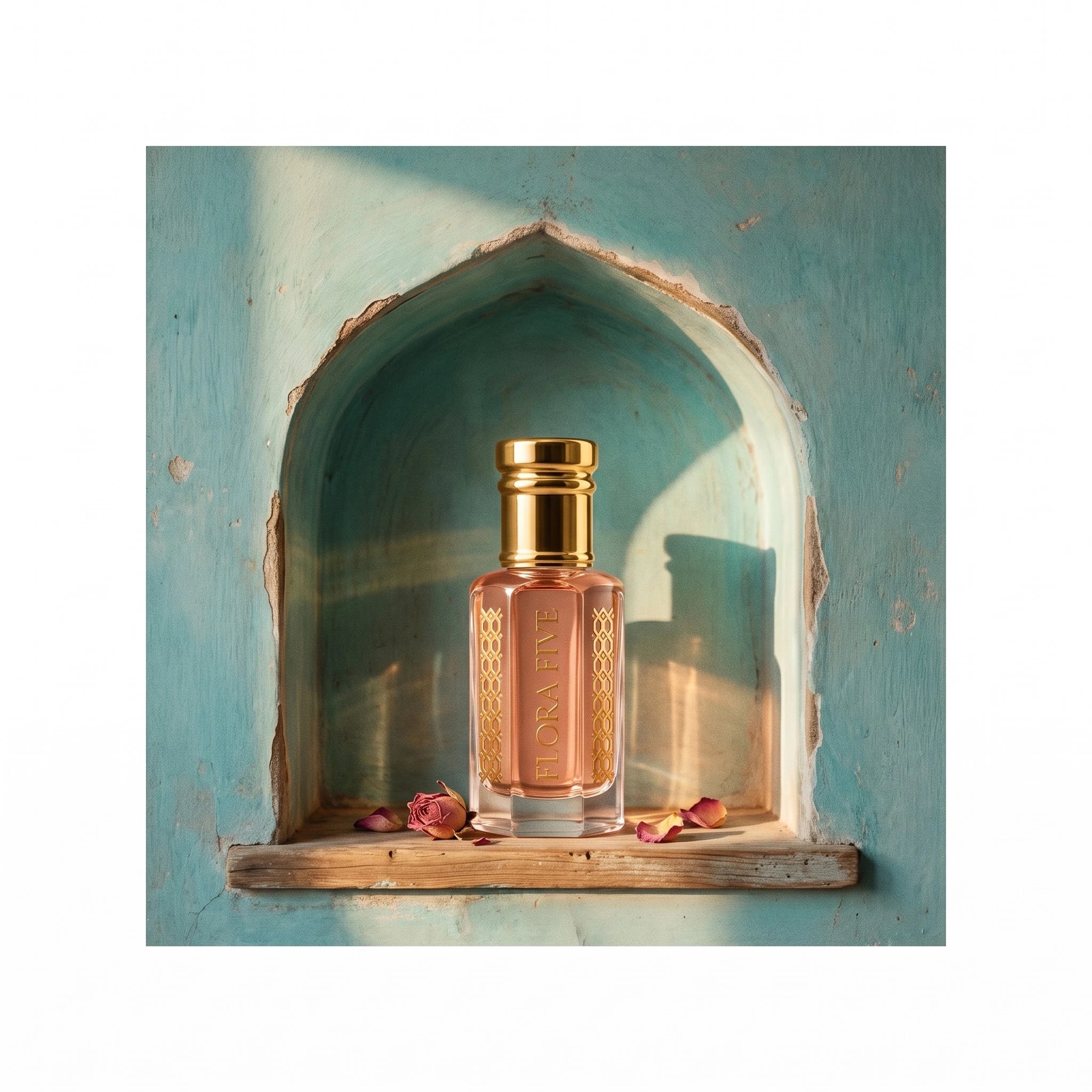 Wesal Attar by Flora Five, alcohol-free attar oil: bottle in a turquoise arched niche with rose petals – 3, 6 and 12 ml