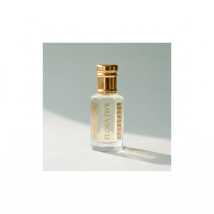 White Firdaus Attar by Flora Five, alcohol-free attar oil: bottle on a pale celadon studio backdrop – 3, 6 and 12 ml