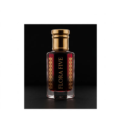 YSL M7 inspired oud for men — alcohol-free oud (oudh) oil by Flora Five: deep red oil in a gold-capped bottle on a black studio backdrop