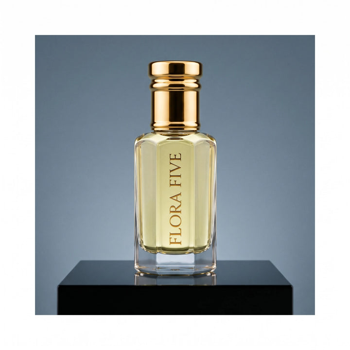 YSL Y inspired attar by Flora Five, alcohol-free perfume oil: bottle on a steel-blue studio backdrop – 3, 6 and 12 ml